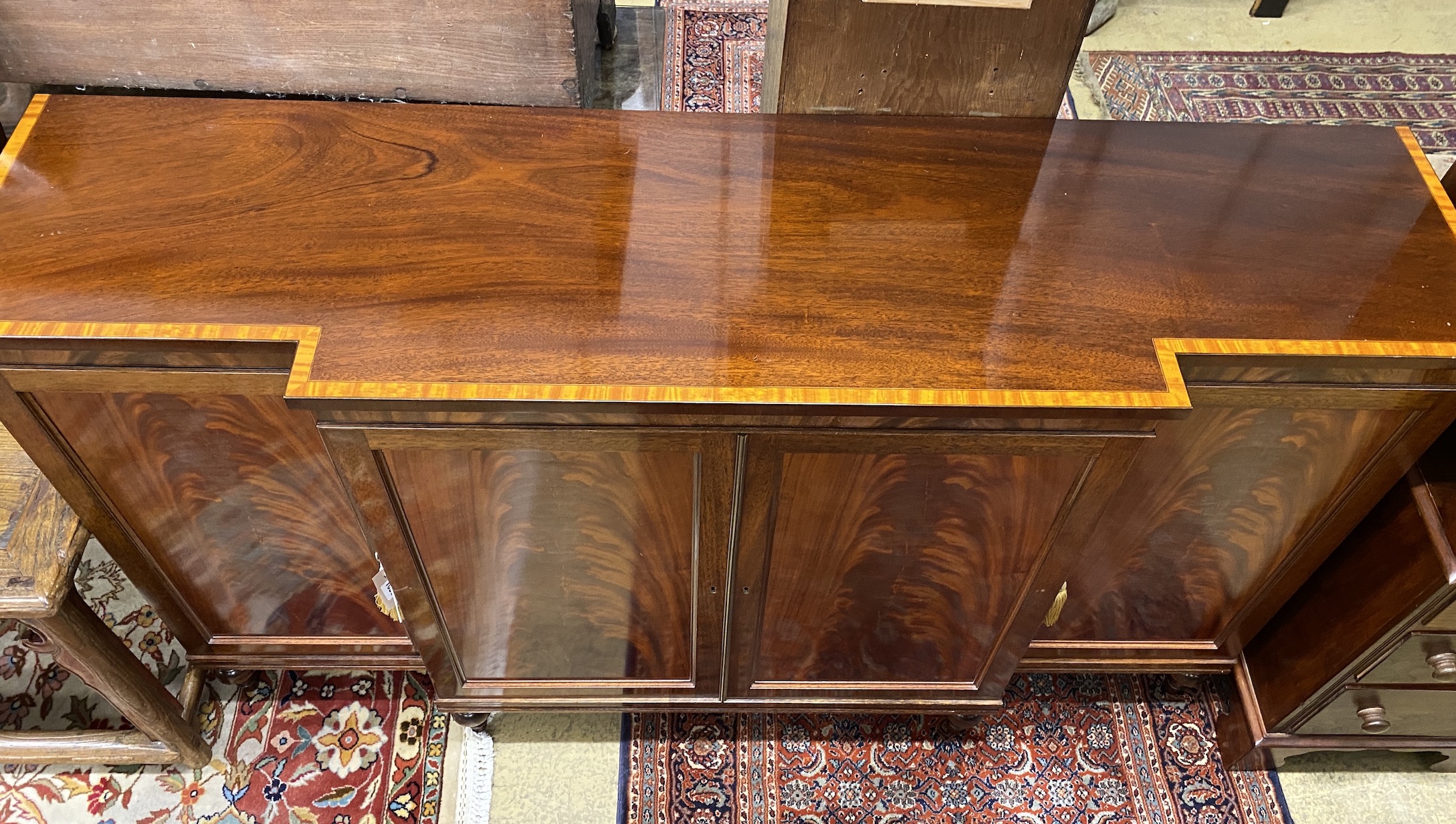 A reproduction satinwood banded mahogany breakfront side cabinet, width 152cm, depth 40cm, height 92cm